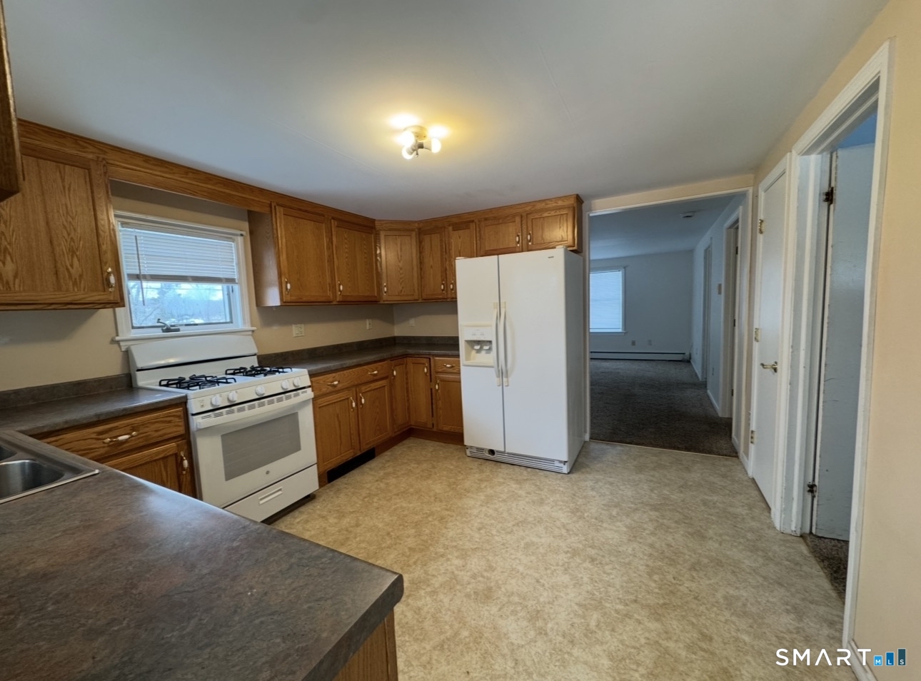 25 Wawecus Hill Road Norwich, CT 06360 - Photo 4 of 13 a kitchen with a refrigerator a stove top oven a sink and dishwasher