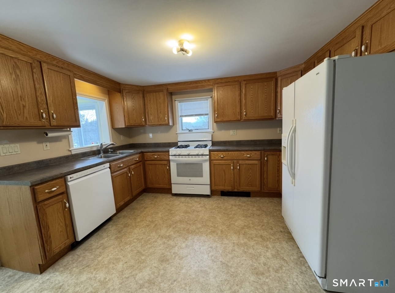 25 Wawecus Hill Road Norwich, CT 06360 - Photo 5 of 13 a kitchen with a refrigerator sink and cabinets