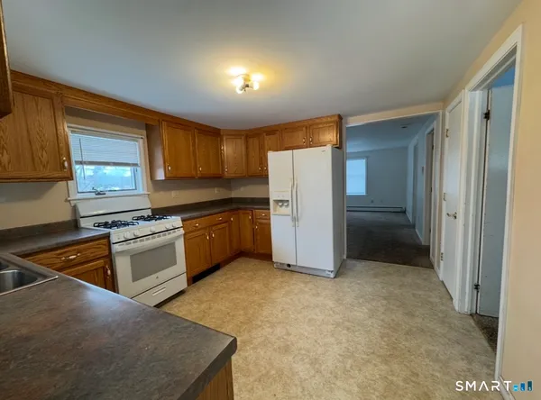 a kitchen with a refrigerator a stove top oven a sink and dishwasher