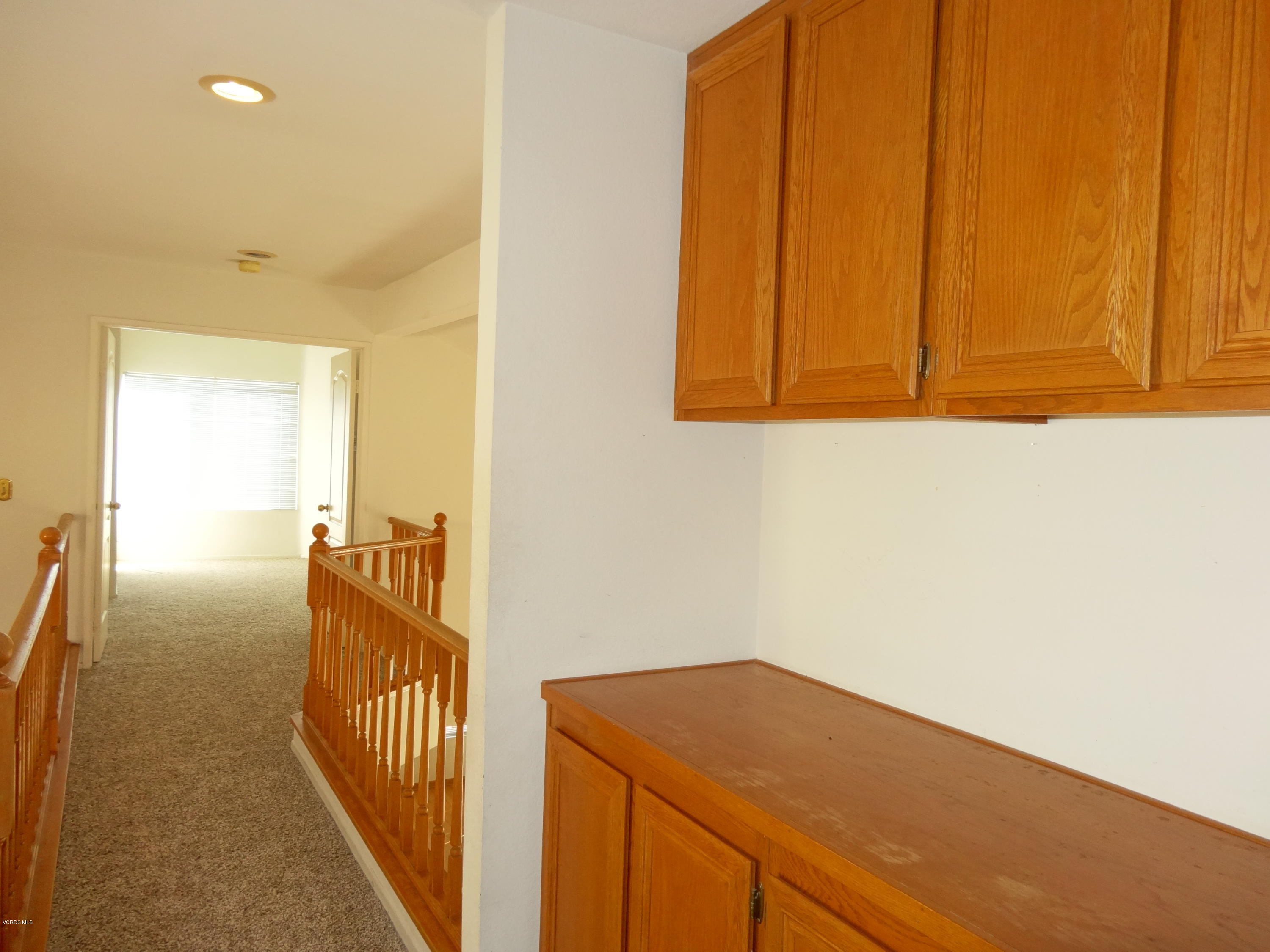 32 Valley Crest Road Simi Valley, CA 93065 - Photo 30 of 39 a view of a hallway to a room with wooden floor
