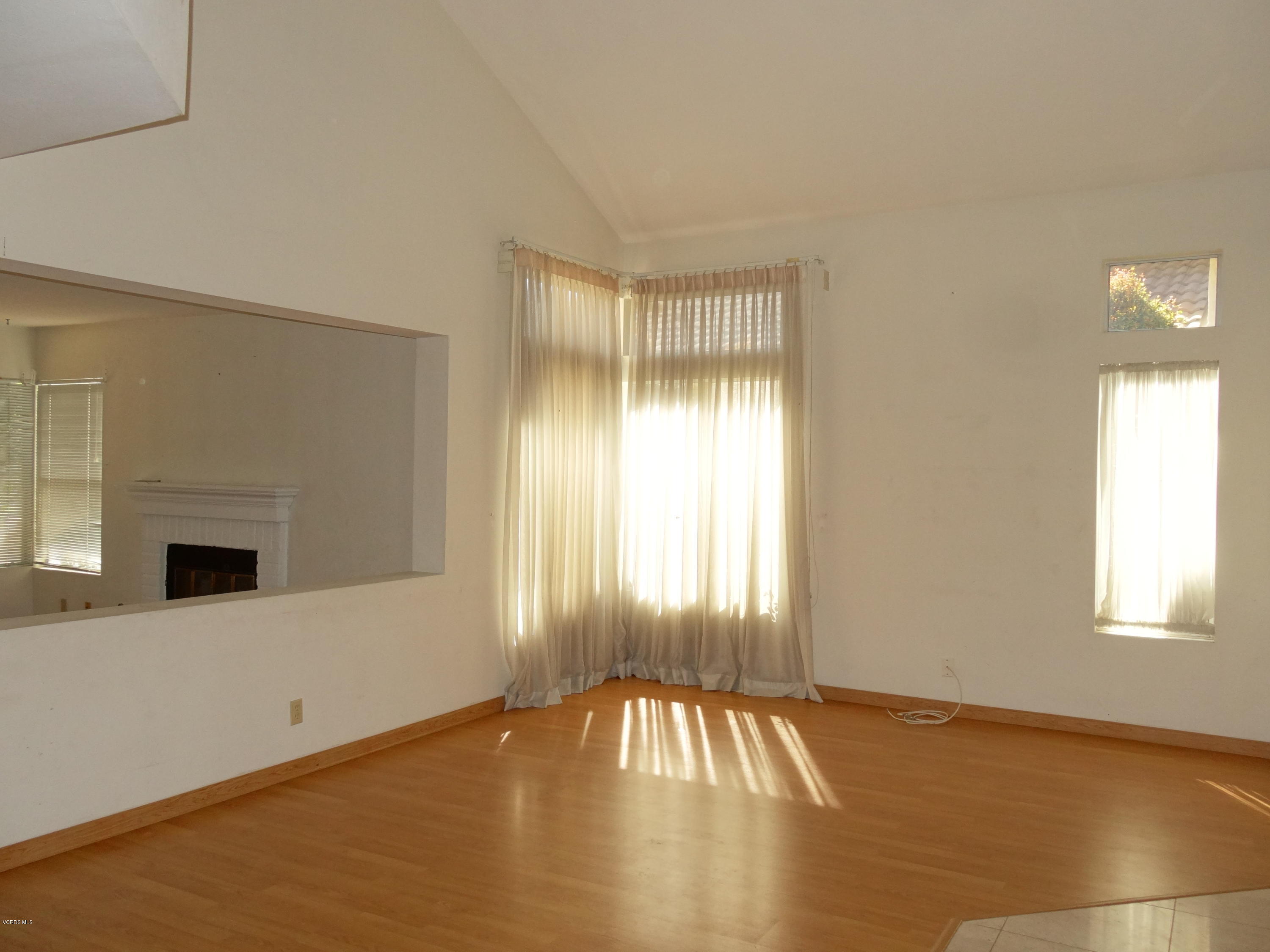 32 Valley Crest Road Simi Valley, CA 93065 - Photo 5 of 39 a view of an empty room with wooden floor and a window