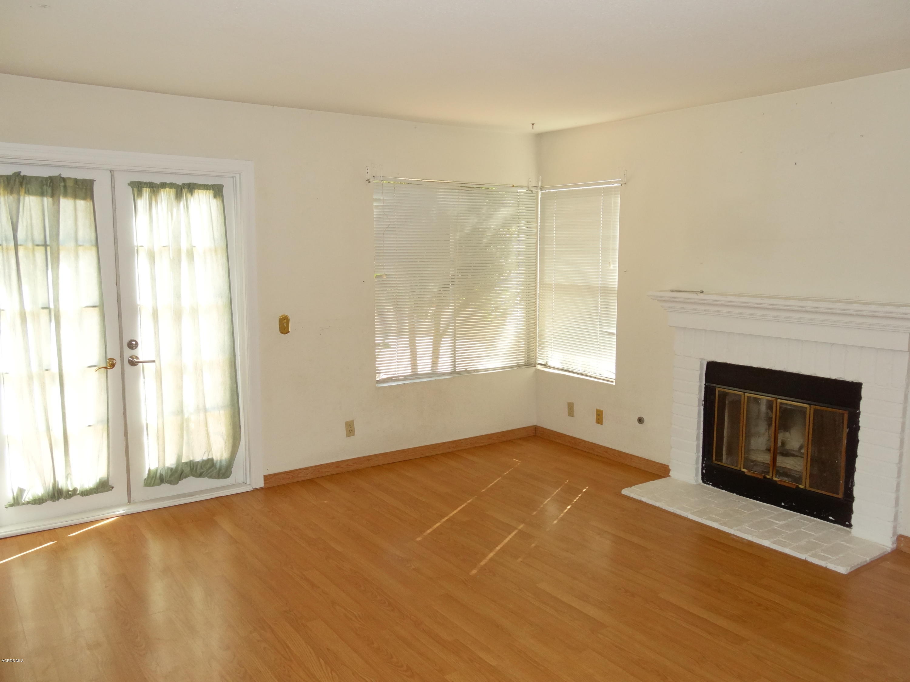 32 Valley Crest Road Simi Valley, CA 93065 - Photo 6 of 39 a view of an empty room with a fireplace and a window