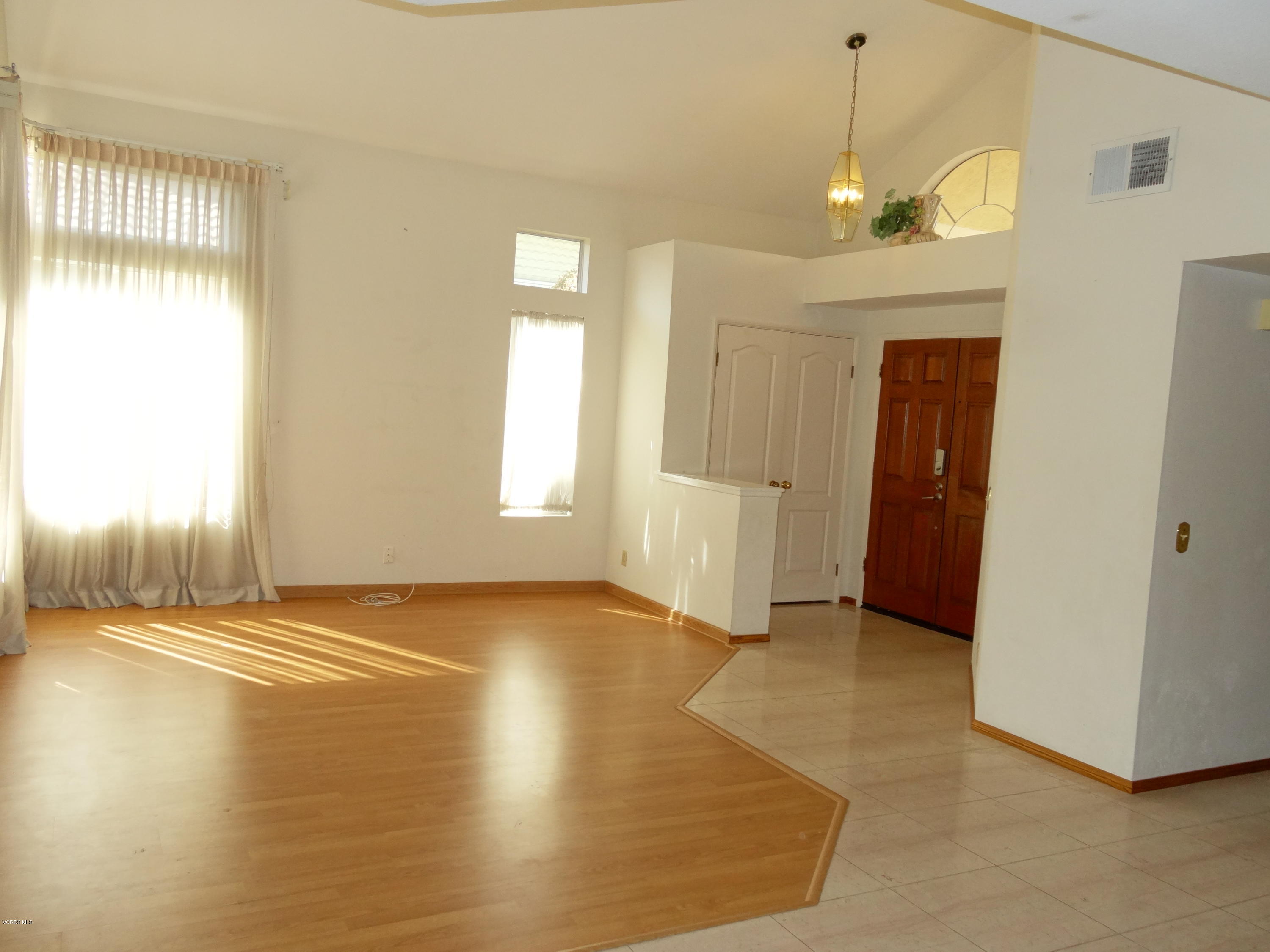 32 Valley Crest Road Simi Valley, CA 93065 - Photo 7 of 39 a view of an empty room with window and wooden floor