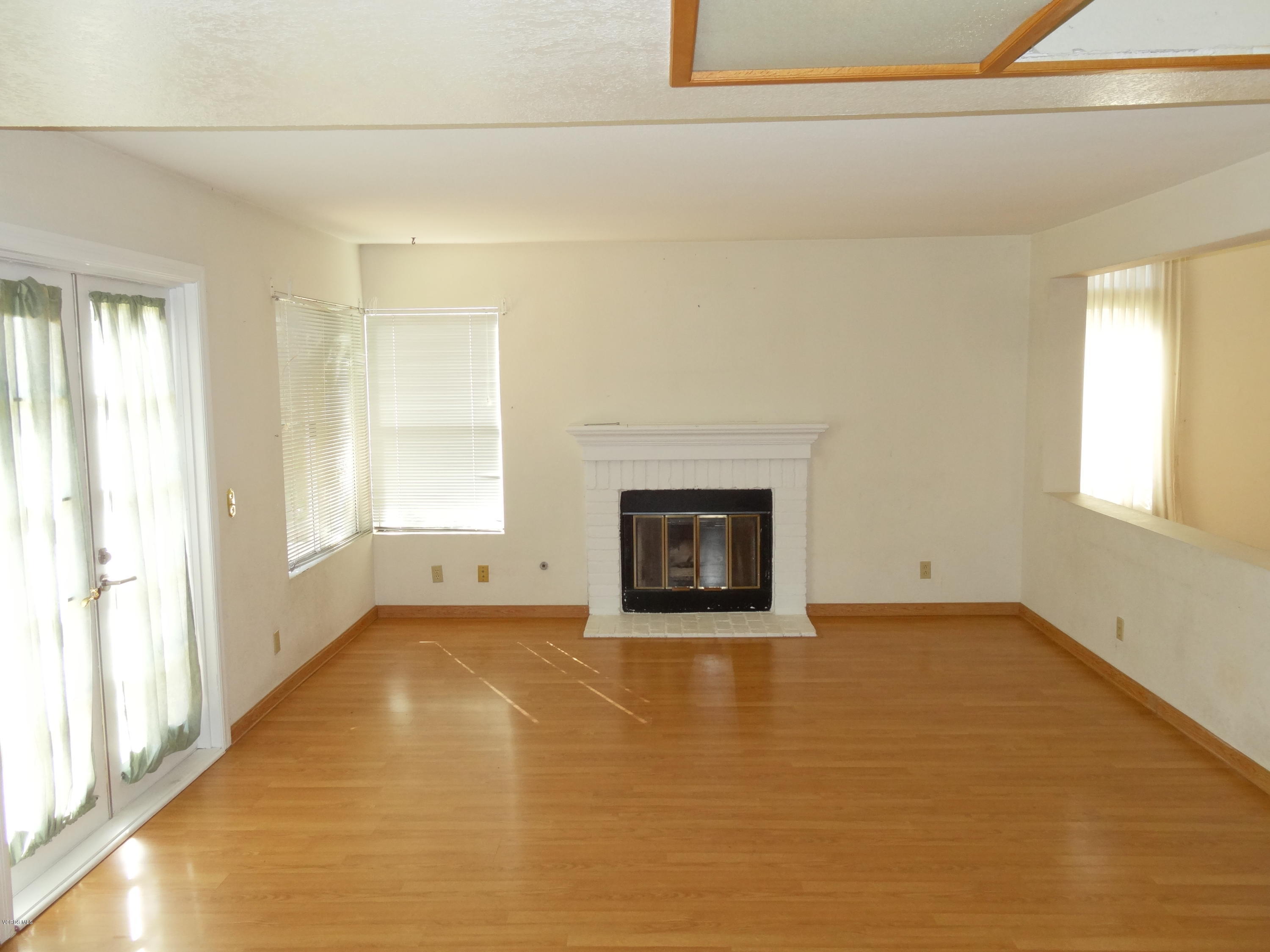 32 Valley Crest Road Simi Valley, CA 93065 - Photo 8 of 39 a view of an empty room with a window and a fireplace