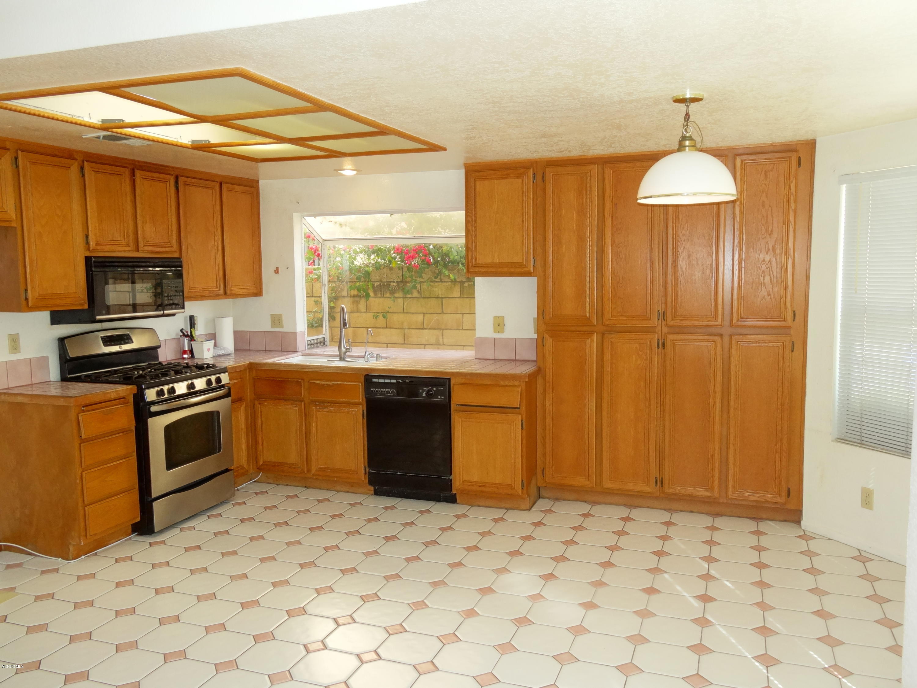32 Valley Crest Road Simi Valley, CA 93065 - Photo 9 of 39 a kitchen with stainless steel appliances granite countertop a stove a sink and a refrigerator