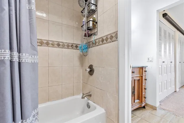 a bathroom with a bathtub and shower