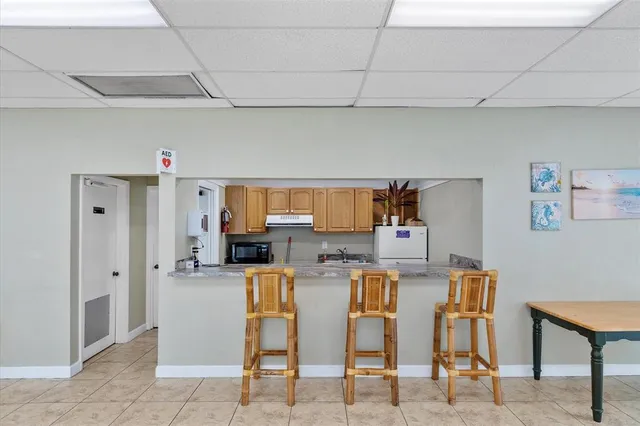 a kitchen with stainless steel appliances kitchen island granite countertop a refrigerator and a stove top oven