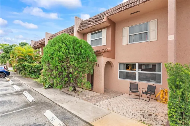 a backyard of a house with outdoor seating