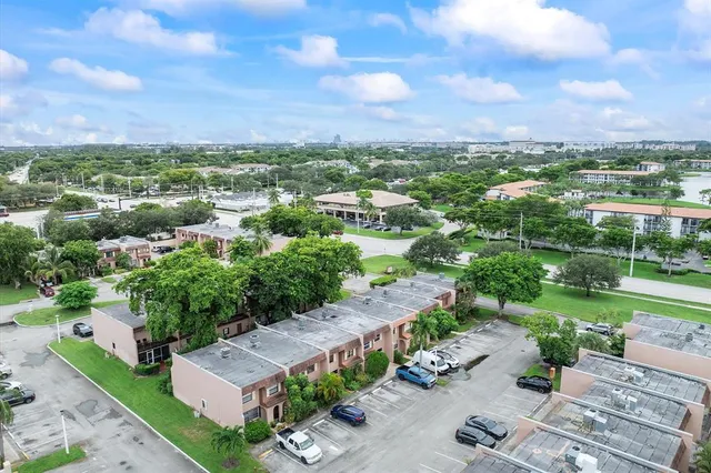 an aerial view of a house with garden space and street view