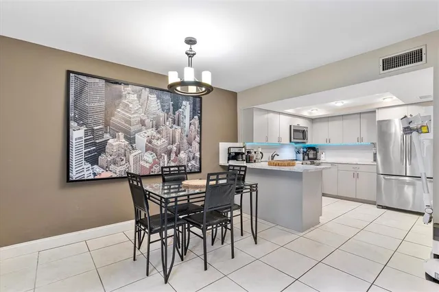 a kitchen with cabinets and chairs
