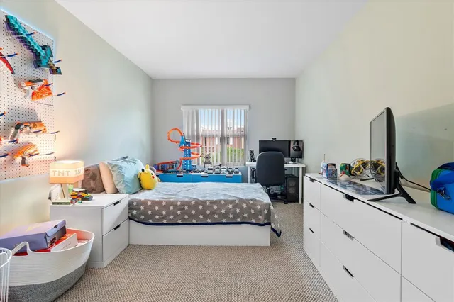 a bedroom with a bed and dresser