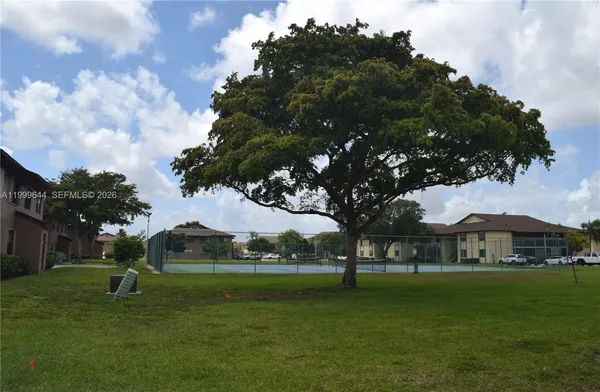 a view of outdoor space with garden and trees