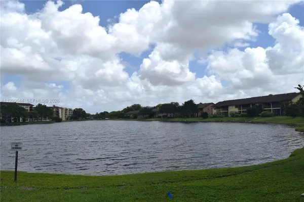 a view of a house with a swimming pool and a yard
