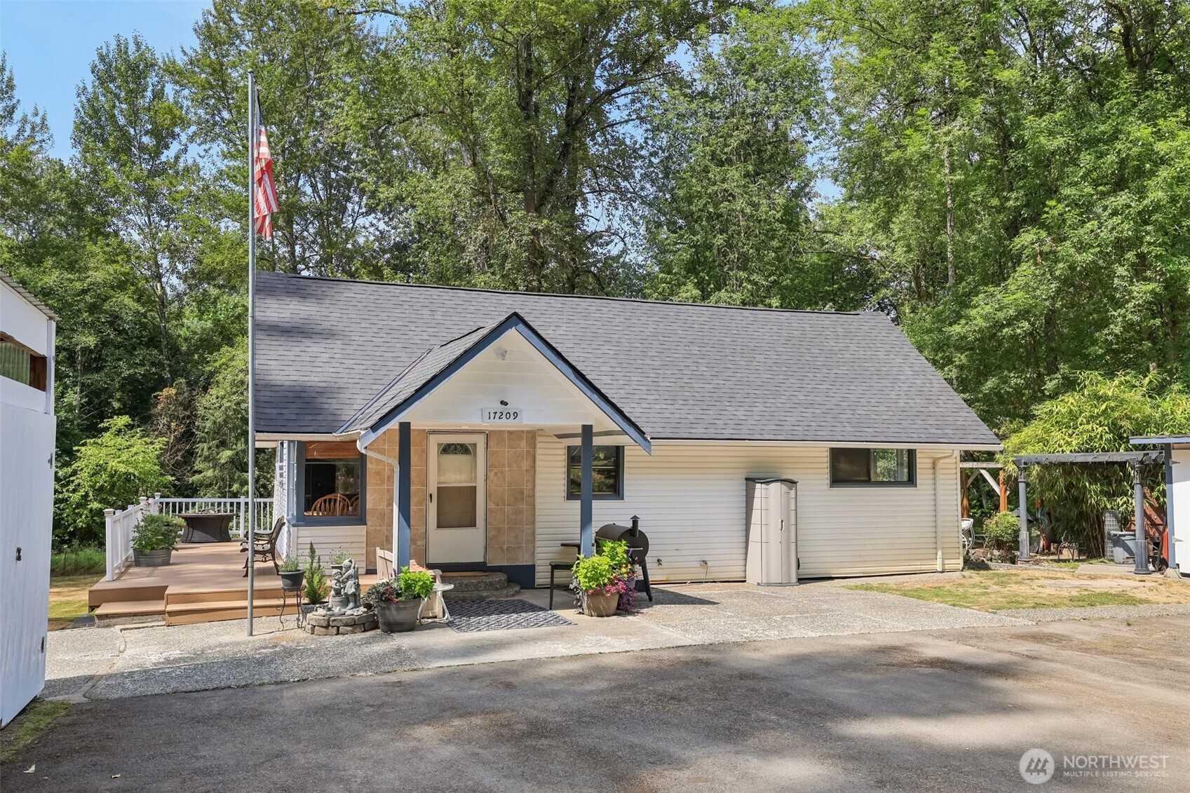 a front view of a house with a garden and patio