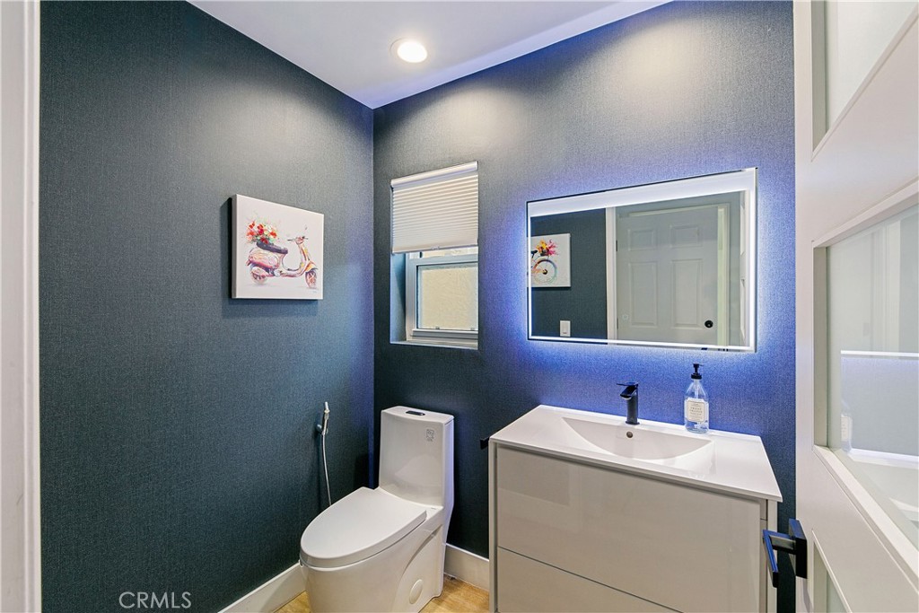24411 Highlander Road West Hills, CA 91307 - Photo 13 of 58 a bathroom with a toilet sink and mirror