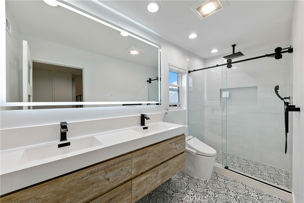 24411 Highlander Road West Hills, CA 91307 - Photo 21 of 58 a bathroom with a sink a toilet a mirror and shower