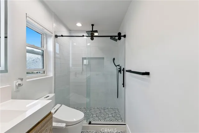 a bedroom with a bed and a large window