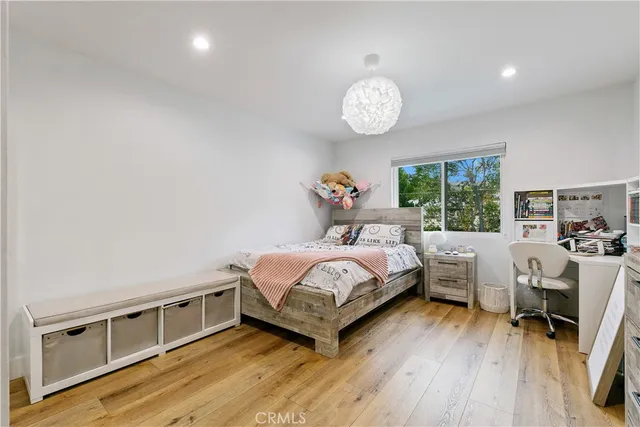 a bedroom with a large bed and a chair