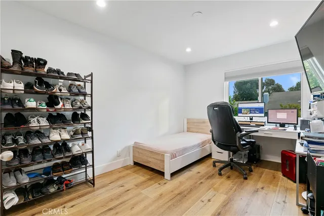 a bedroom with furniture and a flat screen tv