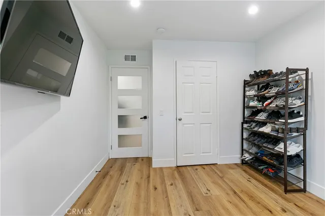 a view of walk in closet with clothes