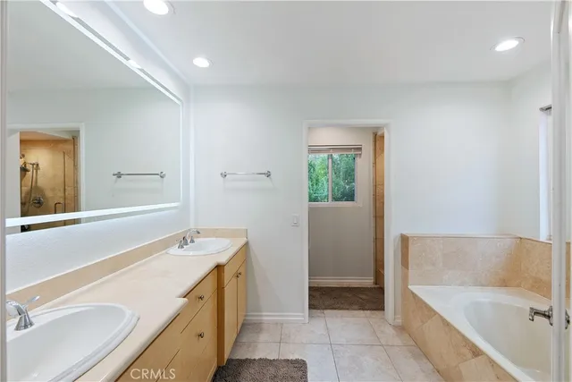 a view of a patio with couches table and chairs under an umbrella with a couch