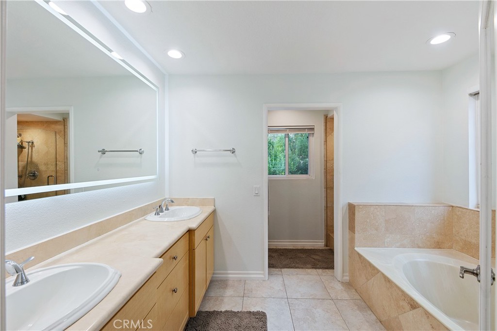 24411 Highlander Road West Hills, CA 91307 - Photo 35 of 58 a bathroom with a tub sink and mirror