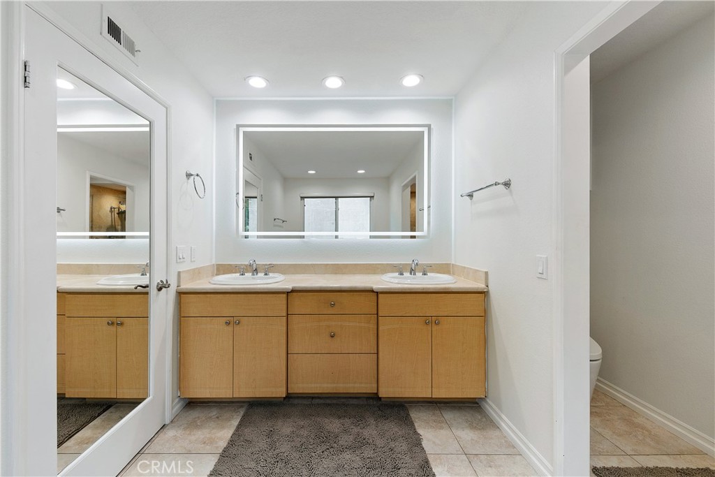 24411 Highlander Road West Hills, CA 91307 - Photo 37 of 58 a spacious bathroom with a double vanity sink and a mirror