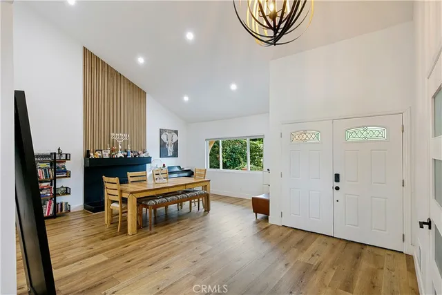 a view of a workspace with furniture and wooden floor