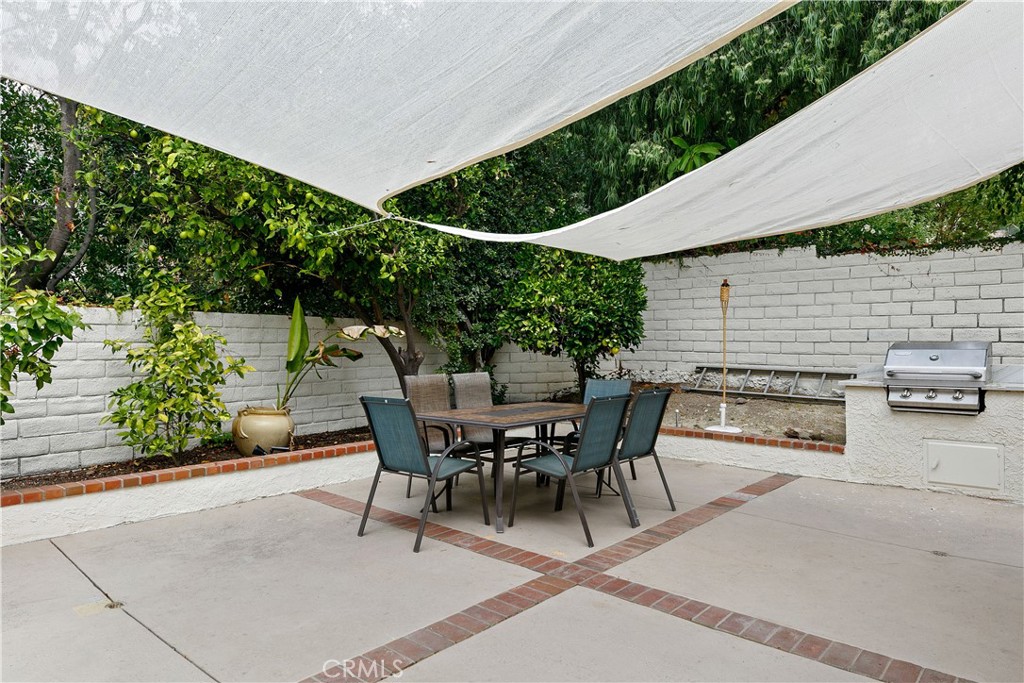 24411 Highlander Road West Hills, CA 91307 - Photo 41 of 58 a view of a patio with table and chairs and potted plants