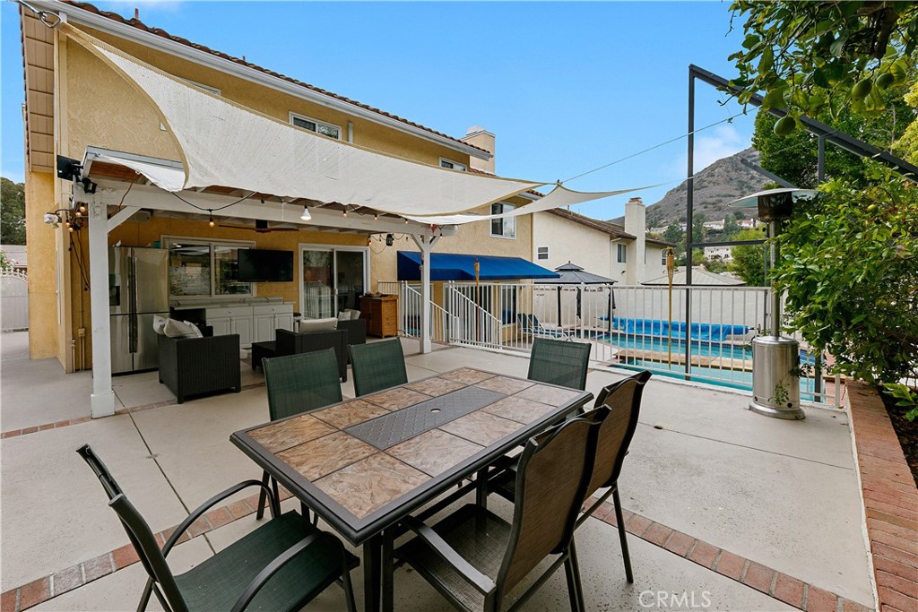 24411 Highlander Road West Hills, CA 91307 - Photo 42 of 58 a view of a patio with a table and chairs