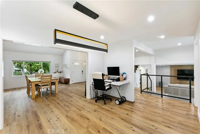 a view of a workspace with furniture and a window