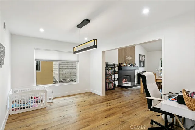 a kitchen with granite countertop a stove a sink a dining table and chairs