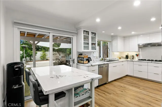 a kitchen with granite countertop white cabinets and white appliances