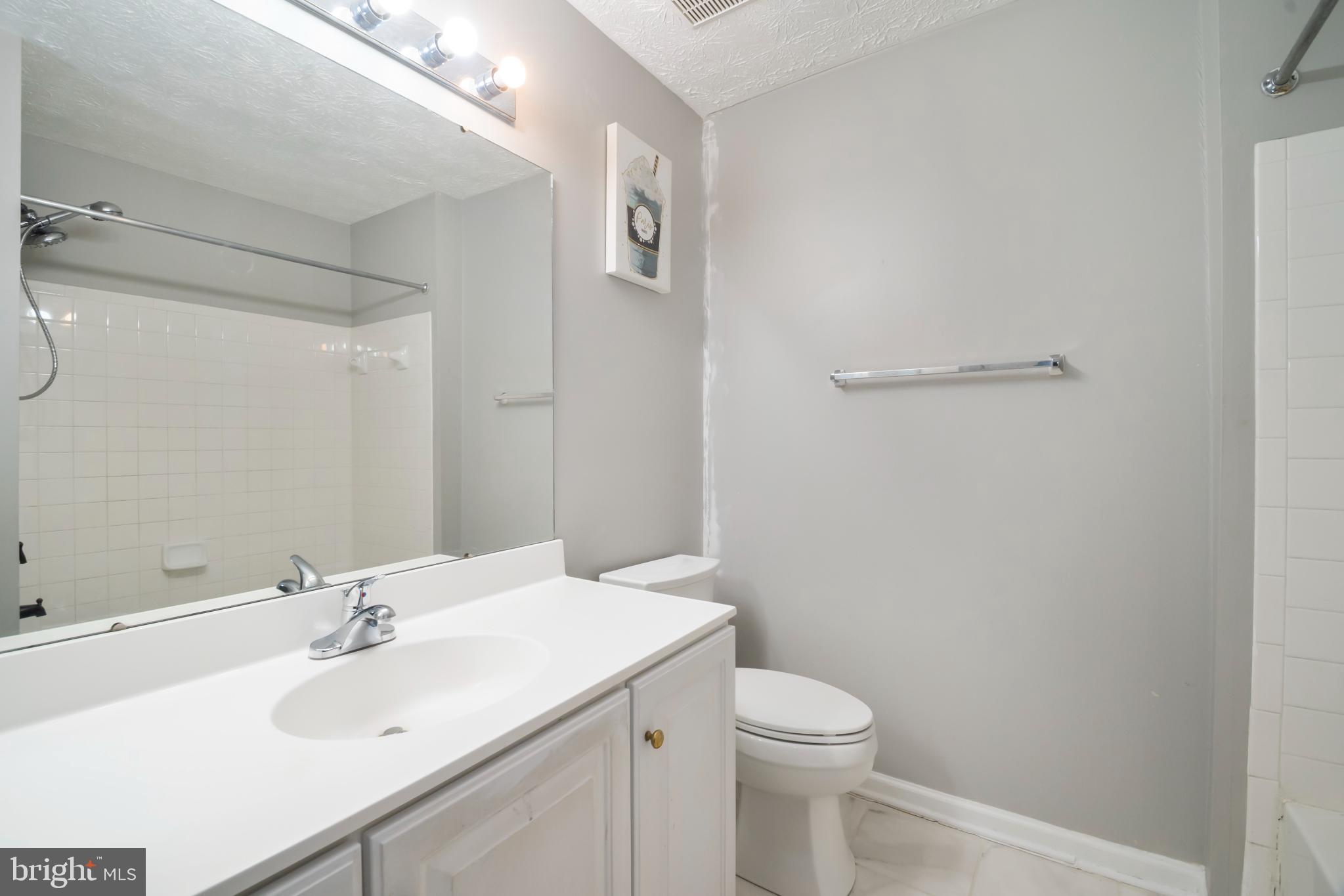 5224 Leavers Court Rosedale, MD 21237 - Photo 14 of 27 a bathroom with a sink a toilet and a mirror