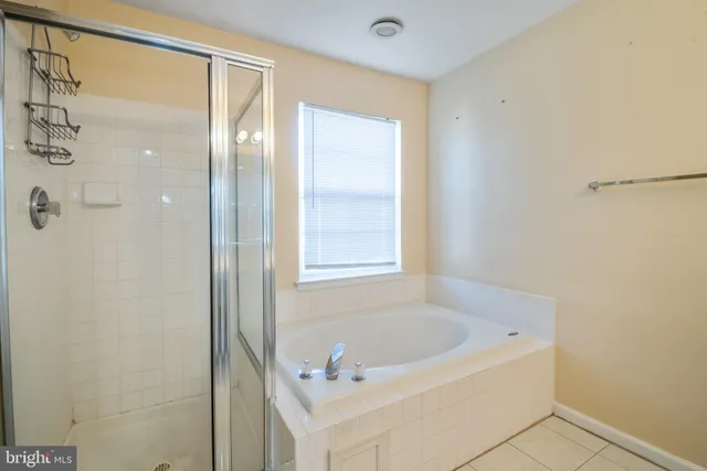 a bathroom with a bathtub and shower