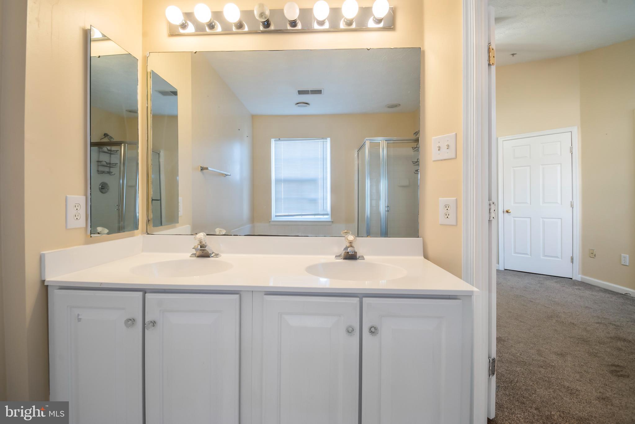 5224 Leavers Court Rosedale, MD 21237 - Photo 21 of 27 a bathroom with a sink and a mirror