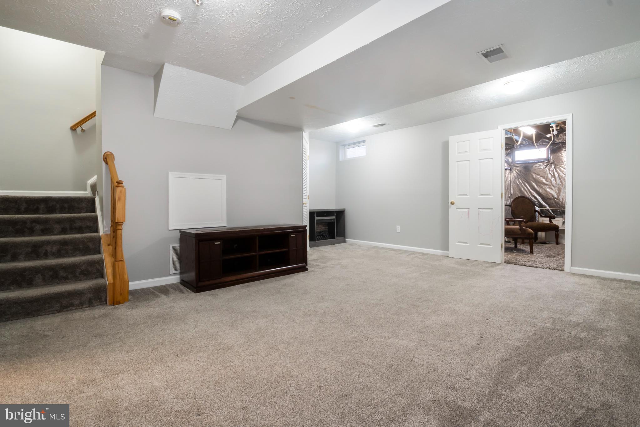 5224 Leavers Court Rosedale, MD 21237 - Photo 22 of 27 a view of empty room with stairs and furniture