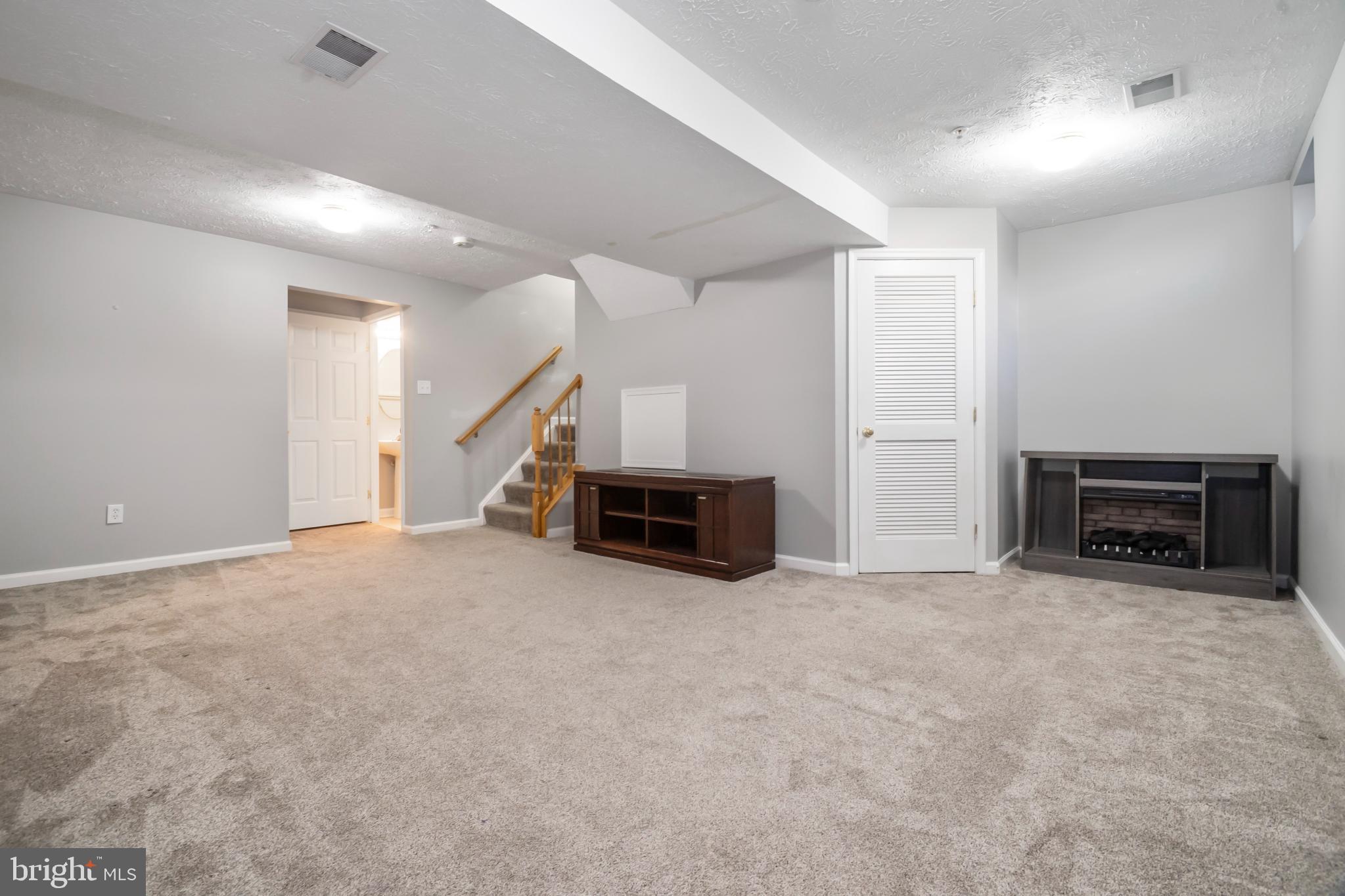 5224 Leavers Court Rosedale, MD 21237 - Photo 23 of 27 an empty room with furniture and a fireplace