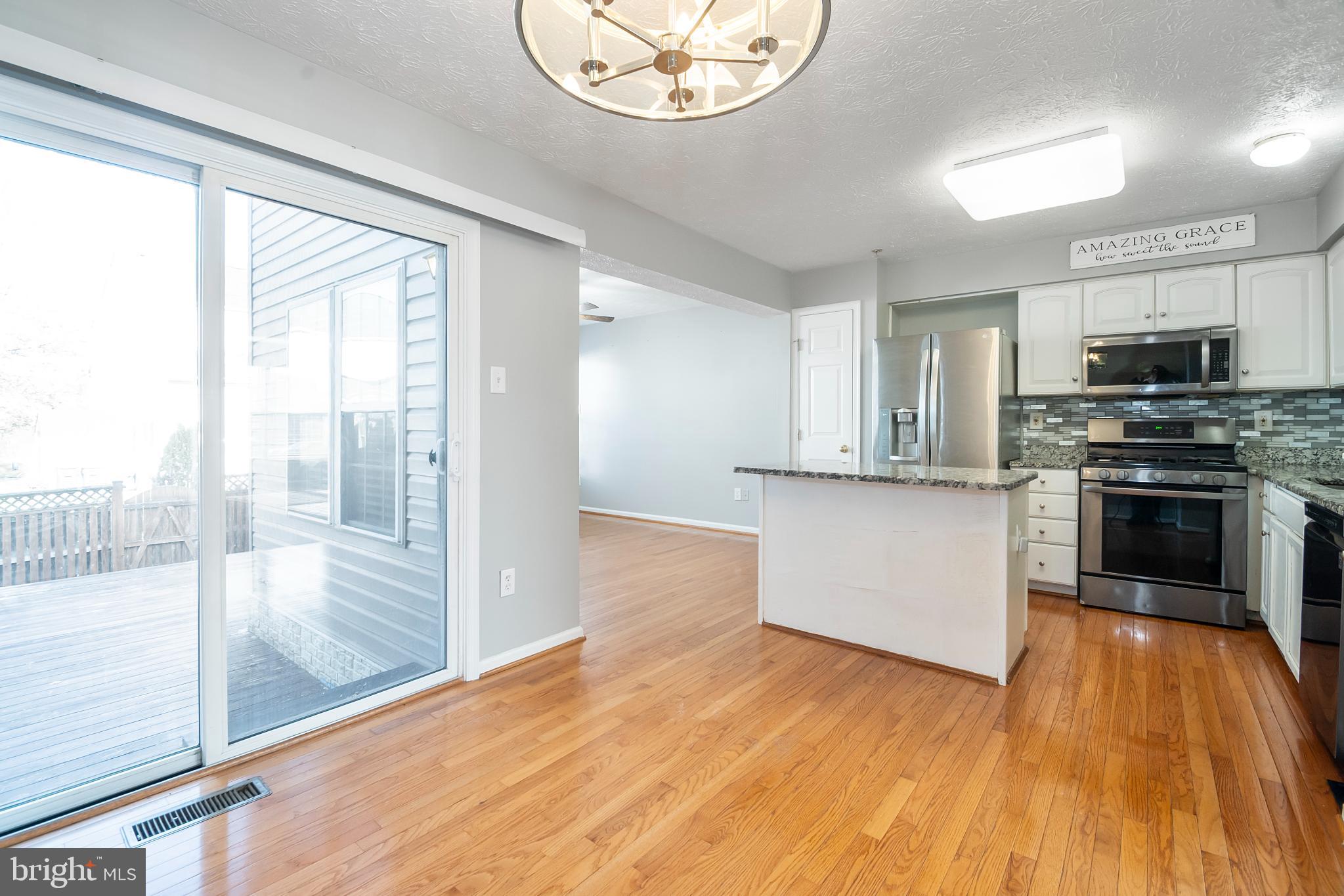 5224 Leavers Court Rosedale, MD 21237 - Photo 8 of 27 a kitchen with stainless steel appliances granite countertop a stove and a refrigerator