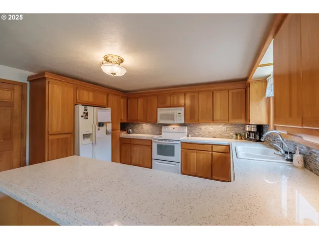 a kitchen with a sink stove and cabinets