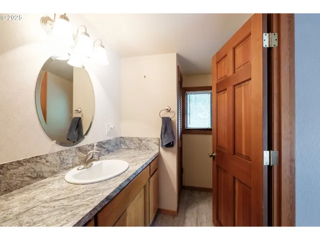 an empty room with windows and chandelier