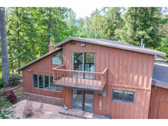 a view of a backyard with table and chairs potted plants and a palm tree