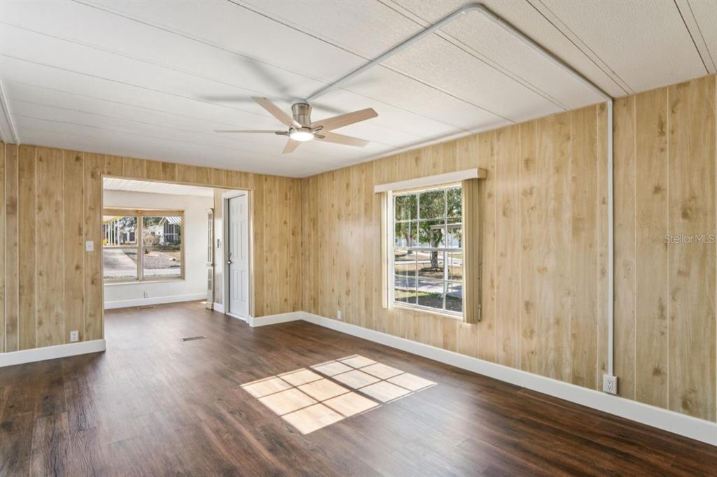 15071 Rialto Avenue Brooksville, FL 34613 - Photo 11 of 41 an empty room with wooden floor and windows