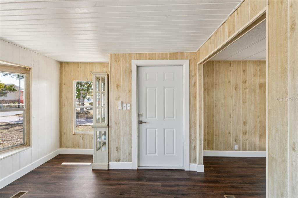 15071 Rialto Avenue Brooksville, FL 34613 - Photo 14 of 41 an empty room with wooden floor and windows