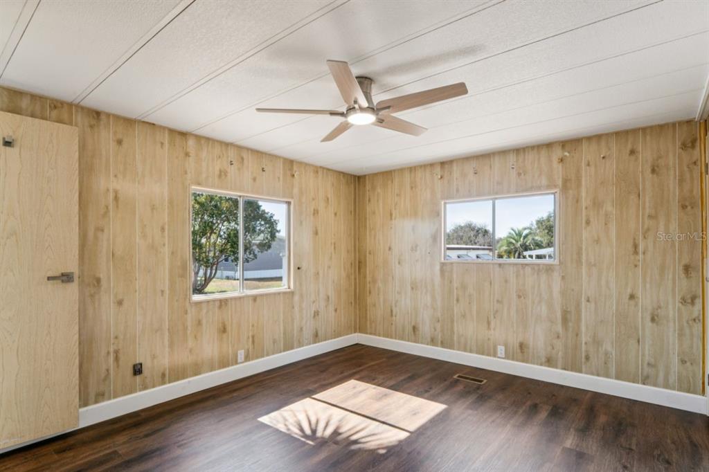 15071 Rialto Avenue Brooksville, FL 34613 - Photo 16 of 41 a view of an empty room with a window and wooden floor
