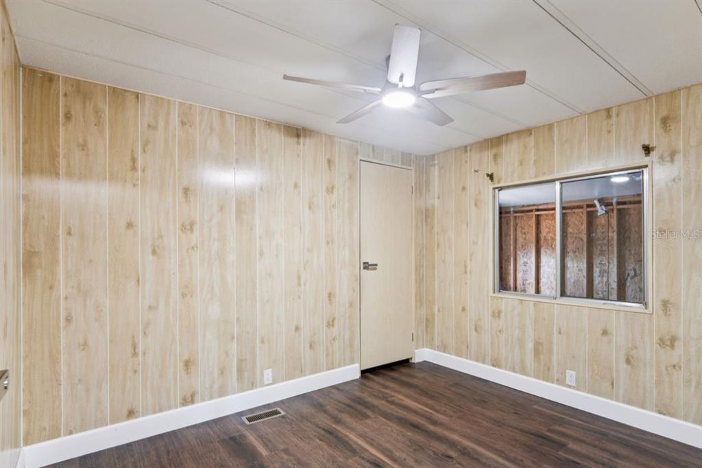 15071 Rialto Avenue Brooksville, FL 34613 - Photo 20 of 41 a view of an empty room with wooden floor