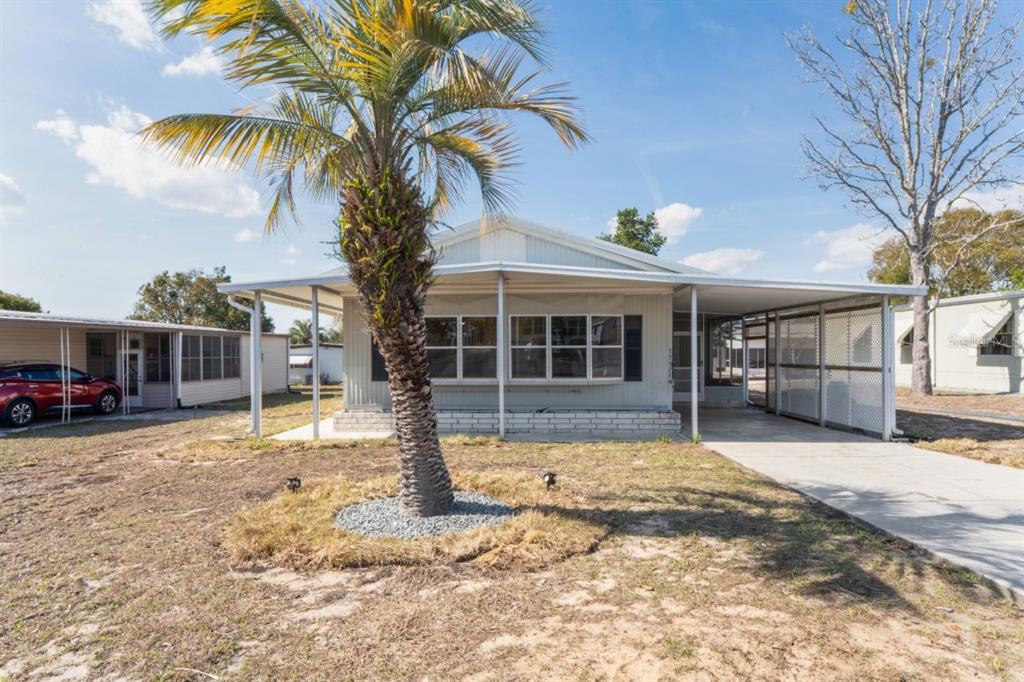 15071 Rialto Avenue Brooksville, FL 34613 - Photo 2 of 41 a front view of a house with a yard and garage