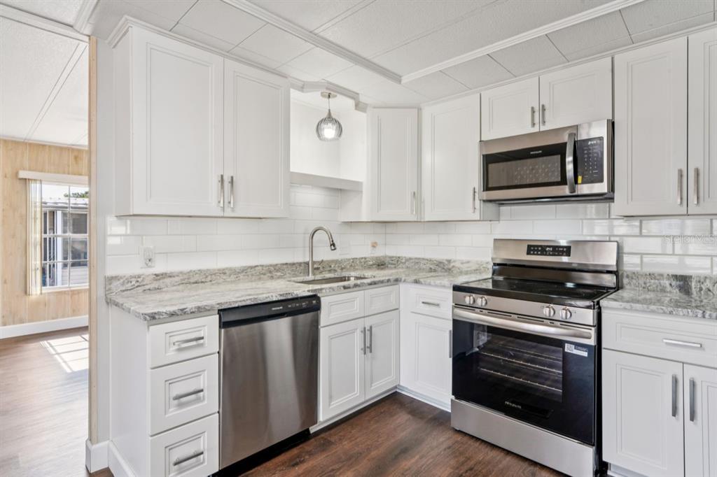 15071 Rialto Avenue Brooksville, FL 34613 - Photo 6 of 41 a kitchen with stainless steel appliances granite countertop a stove and a sink