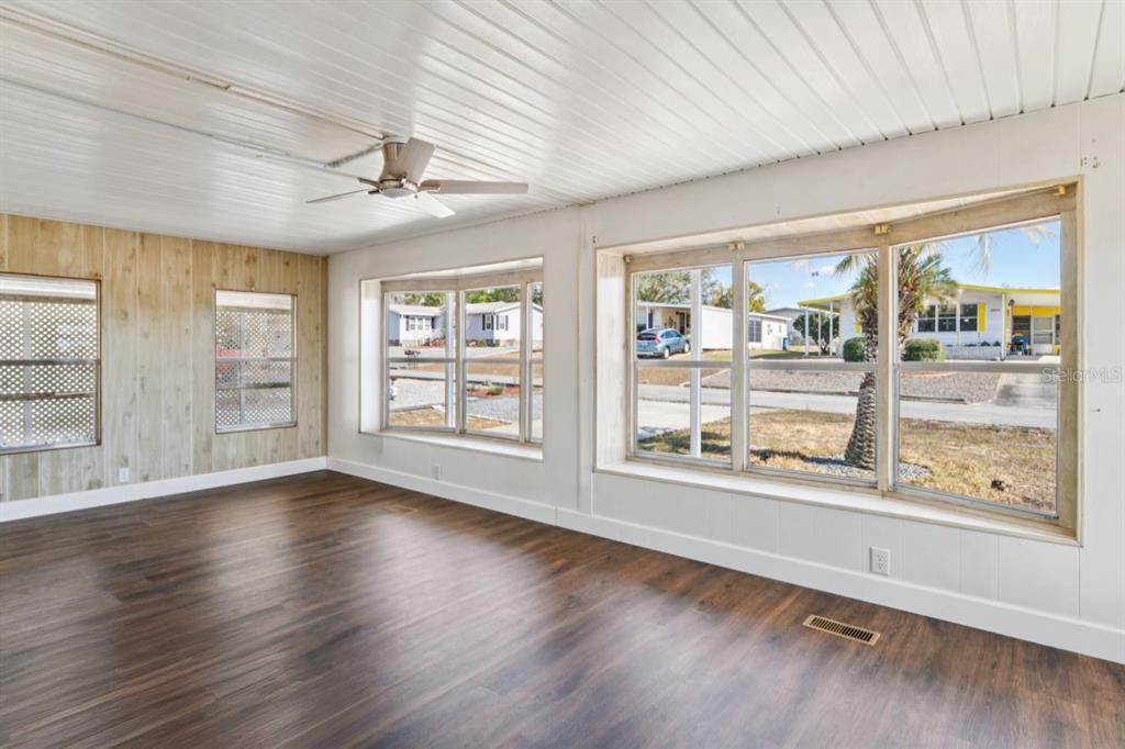 15071 Rialto Avenue Brooksville, FL 34613 - Photo 9 of 41 a view of an empty room with wooden floor and a window