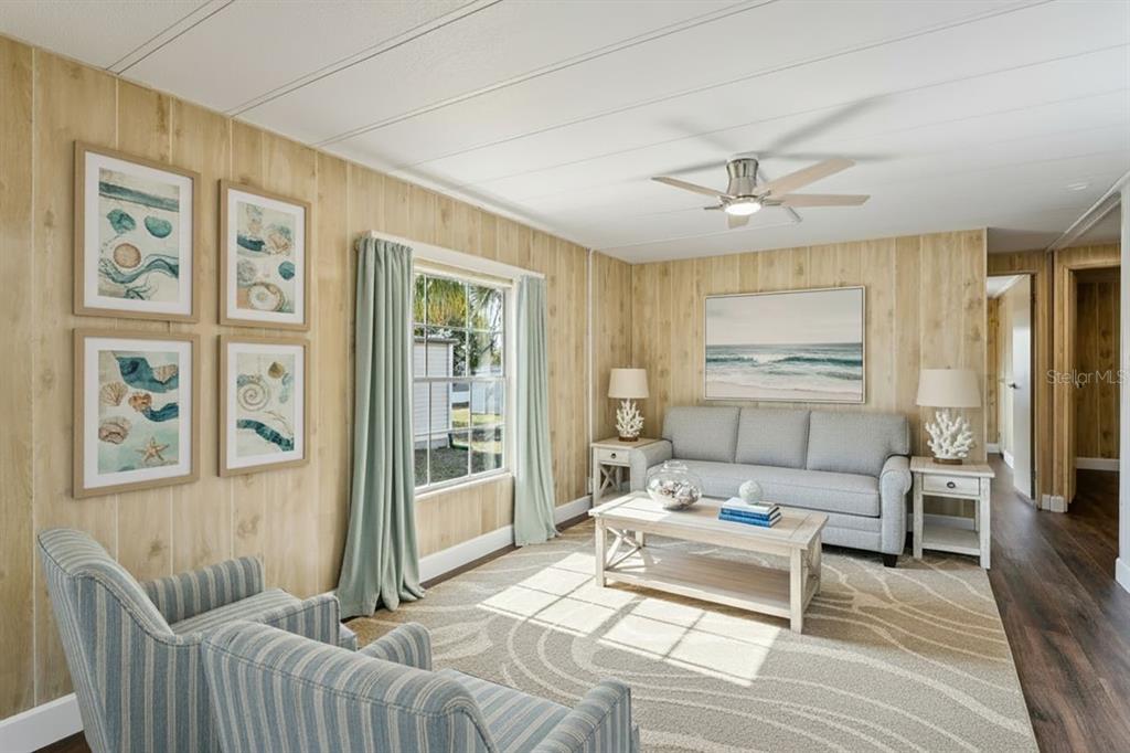 15071 Rialto Avenue Brooksville, FL 34613 - Photo 10 of 41 a living room with furniture a flat screen tv and a table